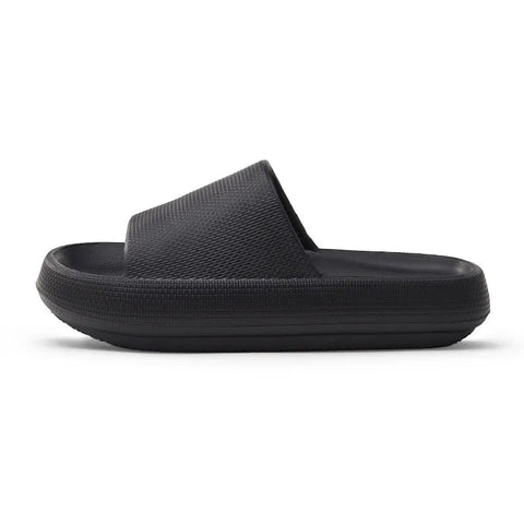 A black slipper with a thick sole, designed for comfort and support.